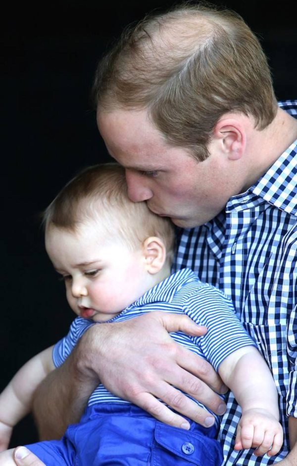 Prince William kisses Prince George during a visit to the Taronga Zoo in Sydney, Australia